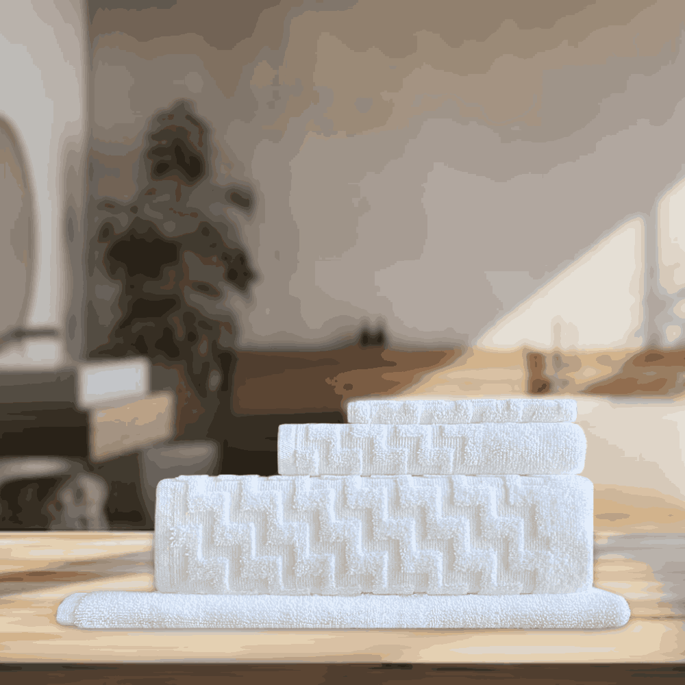 Wholesale hotel towels with an elegant touch, offering versatility in quantity and perfect for enhancing washroom setups for B&Bs and boutique accommodations White folded BWS SERIES Towel Set - Premium 4 pc Set. 