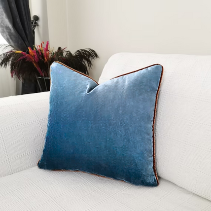 Blue Cushion with brown lining on edges on Sofa